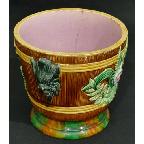 100 - A Majolica round 2-handled trumpet shaped jardiniere on brown, green and pink ground with raised mas... 