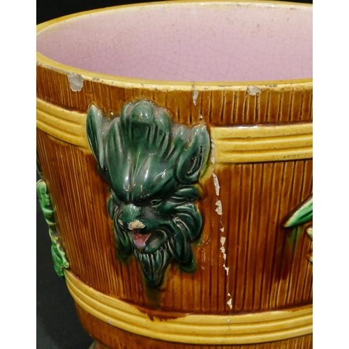 100 - A Majolica round 2-handled trumpet shaped jardiniere on brown, green and pink ground with raised mas... 