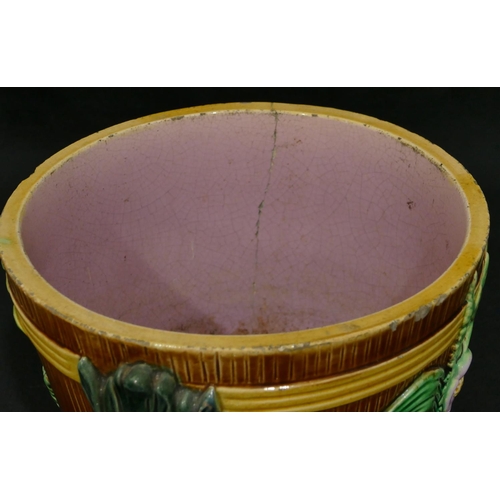 100 - A Majolica round 2-handled trumpet shaped jardiniere on brown, green and pink ground with raised mas... 