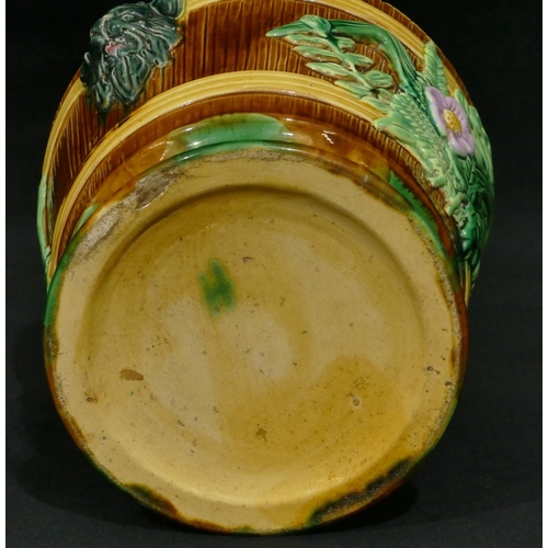 100 - A Majolica round 2-handled trumpet shaped jardiniere on brown, green and pink ground with raised mas... 