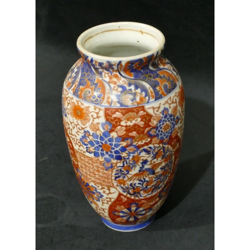 103 - An Imari round bulbous thin necked vase on white, red and blue ground with allover floral, leaf and ... 