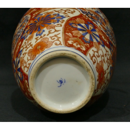 103 - An Imari round bulbous thin necked vase on white, red and blue ground with allover floral, leaf and ... 