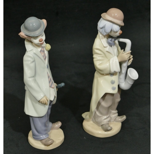 107 - 2 Lladro figures of clowns holding musical instruments, 22cm high. (2)