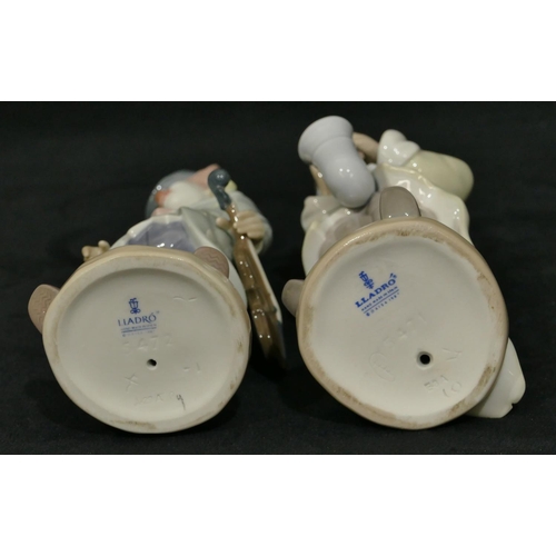 107 - 2 Lladro figures of clowns holding musical instruments, 22cm high. (2)