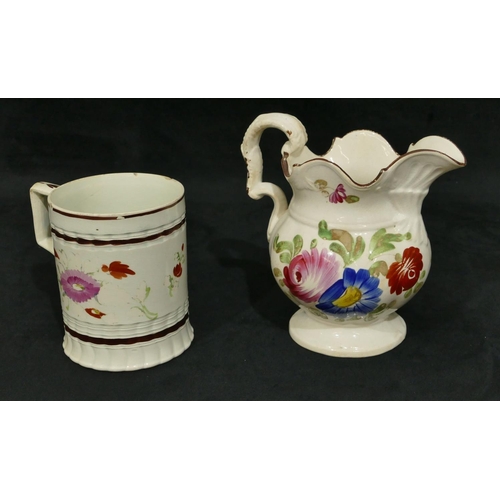 113 - A 19th Century Staffordshire tankard with hand painted floral and leaf decoration, 12.2cm high (2 ch... 