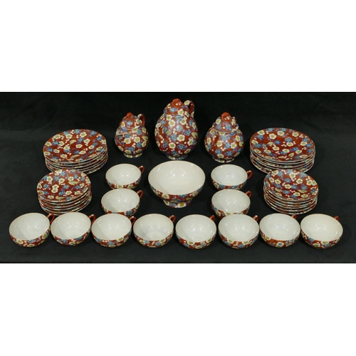 114 - An Oriental eggshell service on red ground with multi-coloured bird, branch and blossom decoration, ... 