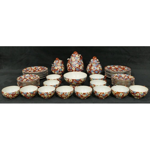 114 - An Oriental eggshell service on red ground with multi-coloured bird, branch and blossom decoration, ... 