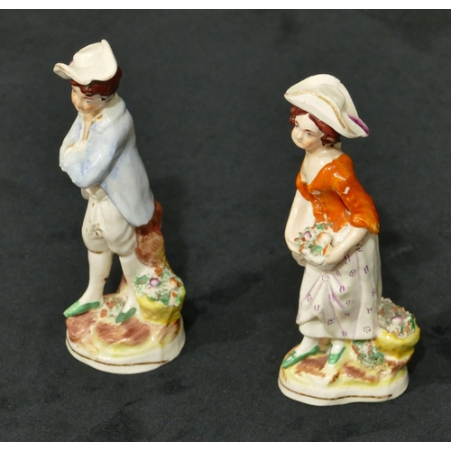 117 - A pair of Staffordshire figures of standing gentleman and lady with baskets of encrusted flowers, 13... 