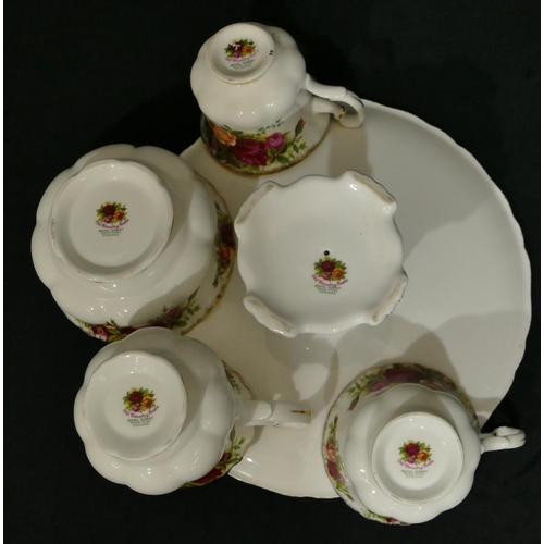 16 - A Royal Albert Country Roses patterned service, teapot, coffee pot (chipped spout), milk jug, sugar ... 