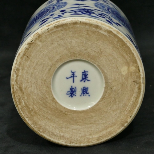 46 - An Oriental blue and white cylindrical brush pot with raised floral and leaf decoration, 15.5cm high... 