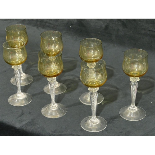 55 - A set of 7 hock glasses with amber coloured bowls on clear hexagonal stems and round bases, 18cm hig... 