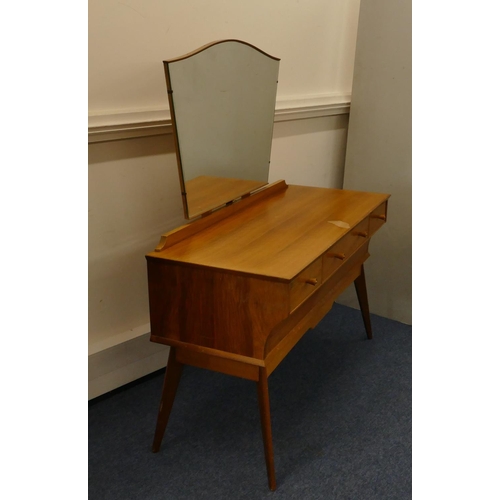 629 - A 1950's walnut dressing table with shaped swing mirror, 3 drawers with wood knob handles above 1 lo... 