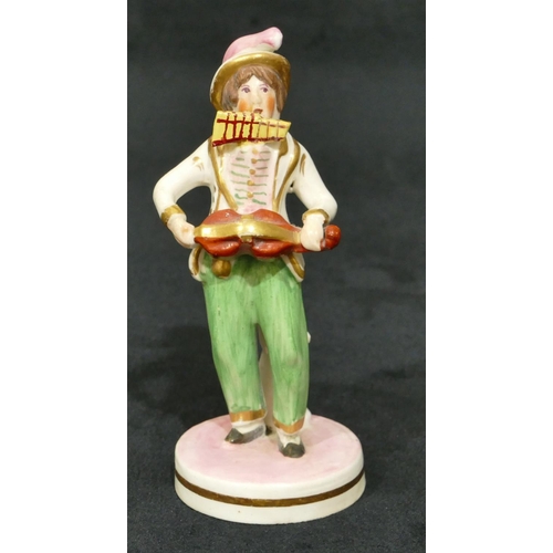 63 - A 19th Century Staffordshire figure of a standing gentleman playing mouth organ and violin on round ... 