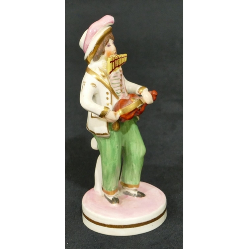 63 - A 19th Century Staffordshire figure of a standing gentleman playing mouth organ and violin on round ... 