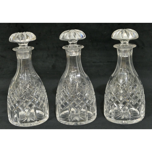 67 - A set of 3 cut glass round bulbous thin necked decanters with mushroom shaped stoppers, 26.5cm high.