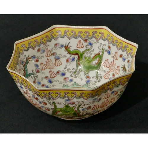 73 - An Oriental eggshell octagonal scallop shaped small bowl on white, yellow and green ground with drag... 