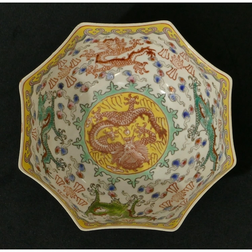 73 - An Oriental eggshell octagonal scallop shaped small bowl on white, yellow and green ground with drag... 