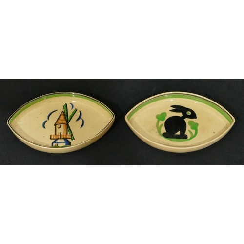 76 - 2 Ashtead Pottery small dishes with windmill and rabbit motif on cream and green ground, 13.5cm wide... 