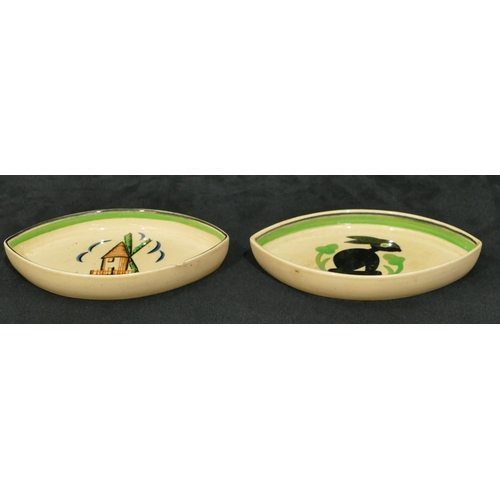 76 - 2 Ashtead Pottery small dishes with windmill and rabbit motif on cream and green ground, 13.5cm wide... 