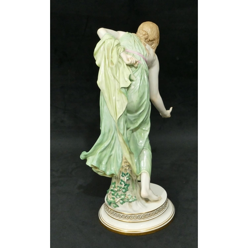 91 - A Meissen large figure of a lady stooping on round base (finger on right hand a/f), 35cm high.