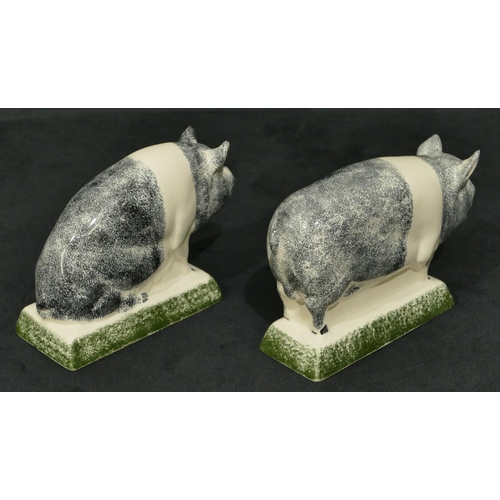 92 - A pair of Rye Pottery figures of pigs on rectangular shaped bases, 16cm long, 11cm high.