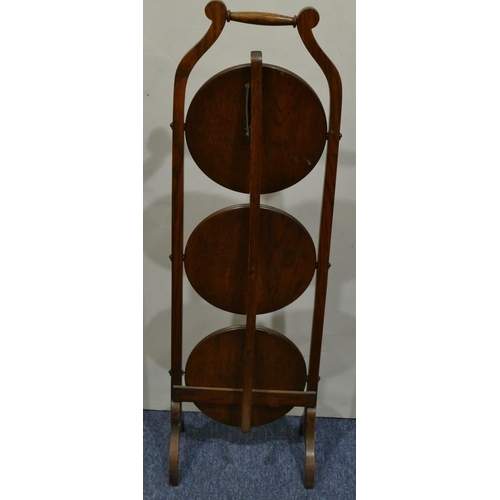 631 - A 1920's oak 3-tier folding cake stand on splayed feet, 91cm high.