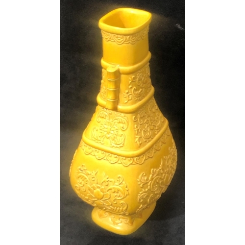 61 - An Oriental rectangular bulbous thin necked 2- handled vase on yellow ground with raised floral and ... 