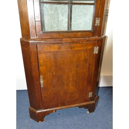 639 - A George III walnut freestanding corner cupboard with glass panel door enclosing shaped shelves, fur... 