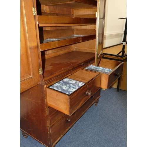 642 - A 19th Century mahogany linen press with 2 panel doors enclosing sliding trays, 2 short and 2 long d... 