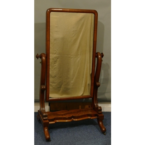 644 - A Victorian mahogany cheval mirror with carved scroll supports, scallop shaped undertier, on splayed... 