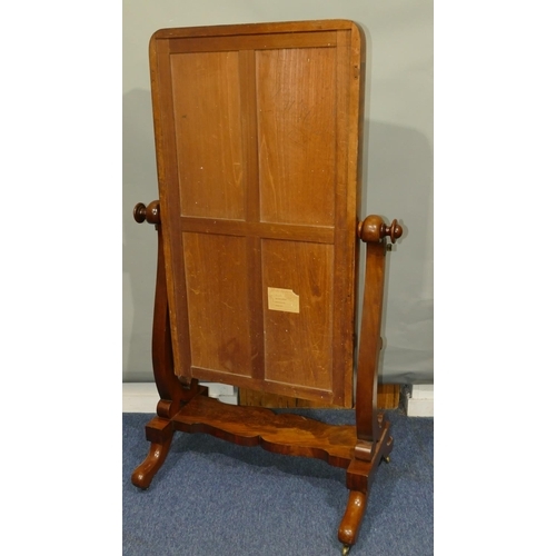 644 - A Victorian mahogany cheval mirror with carved scroll supports, scallop shaped undertier, on splayed... 