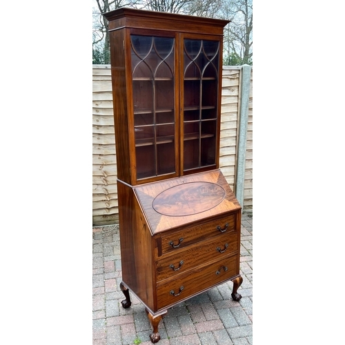 5079 - A 1930's mahogany bureau bookcase, 2 glass panelled doors above fall front, 3 drawers below on cabri... 