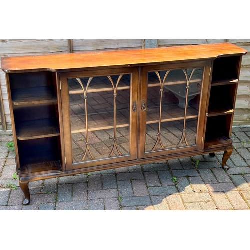 5080 - A mahogany breakfront low display cabinet, 2 glass panelled doors enclosing shelves, flanked by open... 