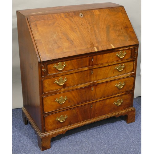 5087 - A George III mahogany bureau with banded decoration, fall front enclosing drawers and pigeon holes, ... 