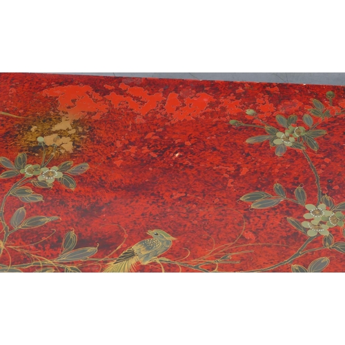 5091 - A modern Oriental red lacquered rectangular shaped coffee table with allover bird, floral, leaf and ... 