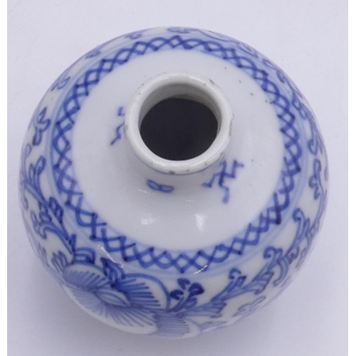 97 - An Oriental small round bulbous thin necked vase on blue and white ground with floral and leaf decor... 