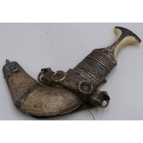 4050 - A Persian silver coloured metal and bone handled Arabian dagger with sheath (part coming away to she... 