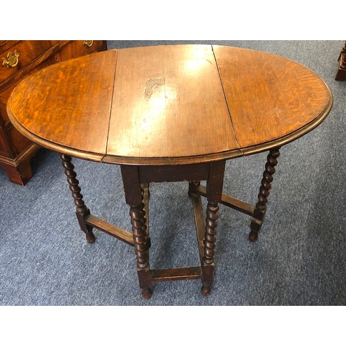 6001 - A 1920's oak oval small gate leg table on barley twist legs, 71.5cm high, 92.5cm wide, 61cm deep.