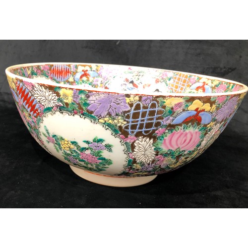 6061 - A large reproduction Oriental multi-coloured punch bowl with allover floral and people decoration, 3... 