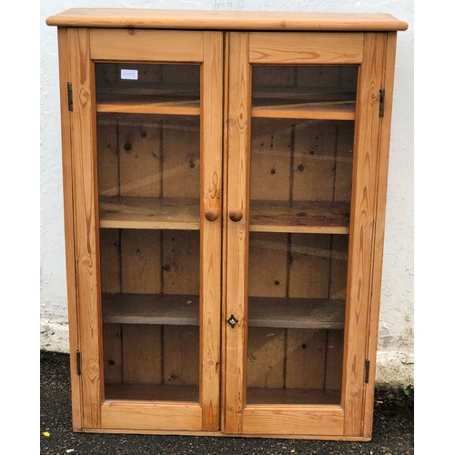 6063 - A pine low display cabinet, 2 glass panel doors, 82cm wide, 30cm deep, 106cm high.