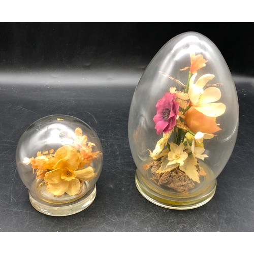 6083 - 2 glass paperweights containing preserved flowers, tallest 18cm high. (2)