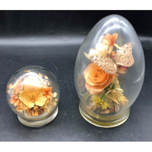 6083 - 2 glass paperweights containing preserved flowers, tallest 18cm high. (2)