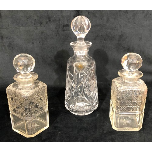 6119 - A pair of cut glass decanters and 1 other cut glass decanter. (3)