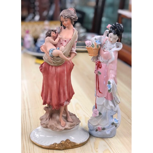 6123 - A figure of a mother and child, 31cm high and an Oriental lady holding basket of flowers, 28cm high.