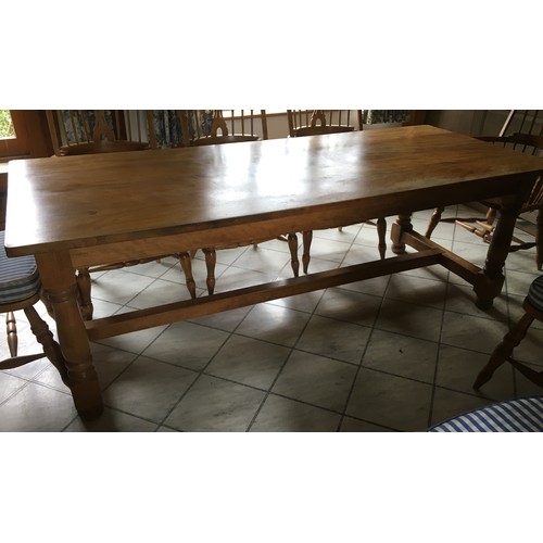 6137 - A pine rectangular table on round turned legs with centre stretcher, 223cm long, 91cm wide, 119cm hi... 