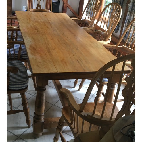 6137 - A pine rectangular table on round turned legs with centre stretcher, 223cm long, 91cm wide, 119cm hi... 