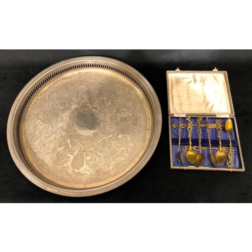 6089 - A silver plated circular tray with engraved decoration 39cm diameter and a set of 6 brass coffee spo... 