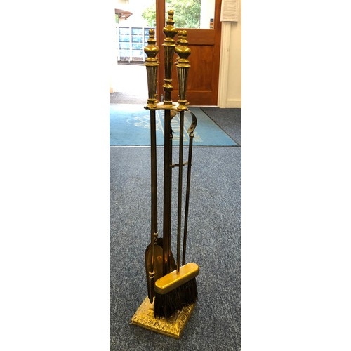 6111 - Set of brass fire irons on brass square base stand, shovel, tongs, brush and poker 75cm high. (5)