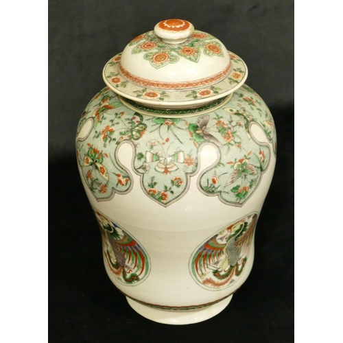 102 - An 18th/19th Century Kangxi round bulbous lidded hinged jar on white ground with multi-coloured butt... 