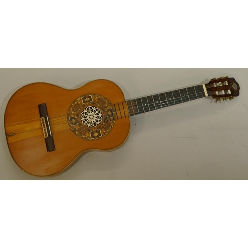 1092 - A classical acoustic Spanish guitar with parquetry decoration and pierced ivory centre in fitted cas... 